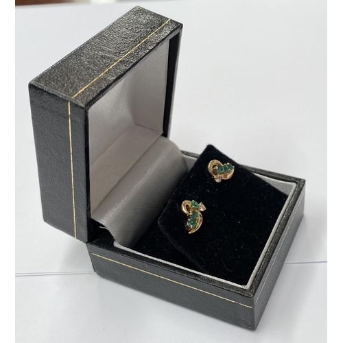 143 - AN ELEGANT PAIR OF 14CT YELLOW GOLD EMERALD & DIAMOND CROSSOVER STYLE EARRINGS; each earring with 3 ... 