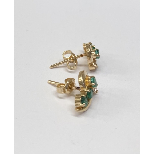 143 - AN ELEGANT PAIR OF 14CT YELLOW GOLD EMERALD & DIAMOND CROSSOVER STYLE EARRINGS; each earring with 3 ... 