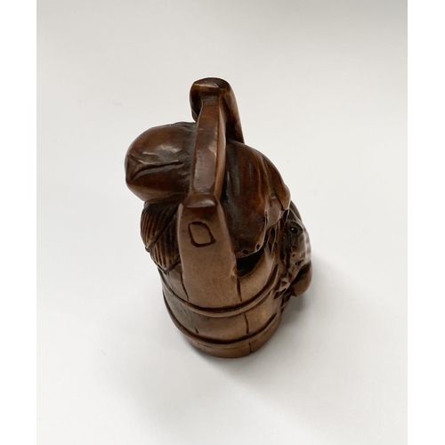 147 - AN EARLY 20TH CENTURY CARVED BOXWOOD NETSUKE of a bucket with two frogs, with signature character ma... 