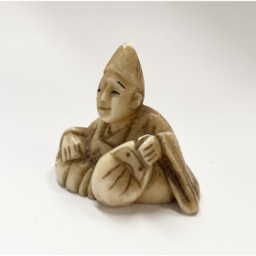 148 - A 19TH CENTURY CARVED IVORY NETSUKE OF A SEATED MAN, robed & wearing a hat, with finely carved detai... 