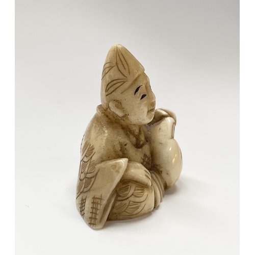 148 - A 19TH CENTURY CARVED IVORY NETSUKE OF A SEATED MAN, robed & wearing a hat, with finely carved detai... 