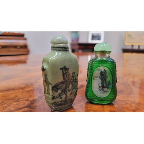 150 - TWO CHINESE SNUFF BOTTLES, (i) A ceramic snuff bottle, with lid and spoon, decorated with images of ... 