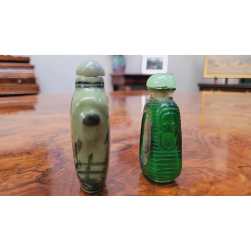 150 - TWO CHINESE SNUFF BOTTLES, (i) A ceramic snuff bottle, with lid and spoon, decorated with images of ... 