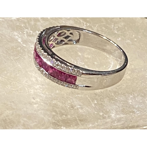 151 - AN 18CT WHITE GOLD RUBY & DIAMOND HALF ETERNITY RING, with a central line of 1.00ct of Burmese rubie... 