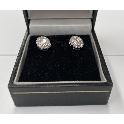 162 - A PAIR OF 18CT WHITE GOLD OVAL DIAMOND CLUSTER STUD EARRINGS, set with round brilliant cut and bague... 