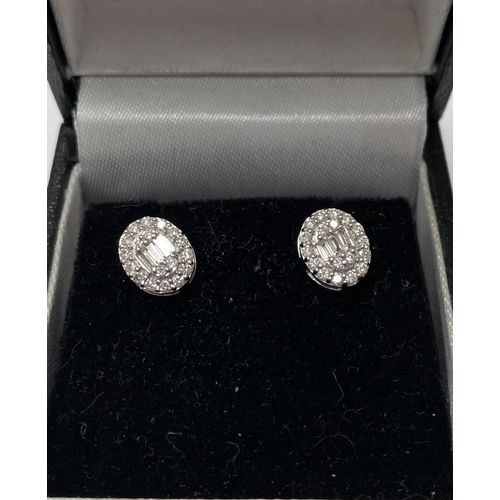 162 - A PAIR OF 18CT WHITE GOLD OVAL DIAMOND CLUSTER STUD EARRINGS, set with round brilliant cut and bague... 