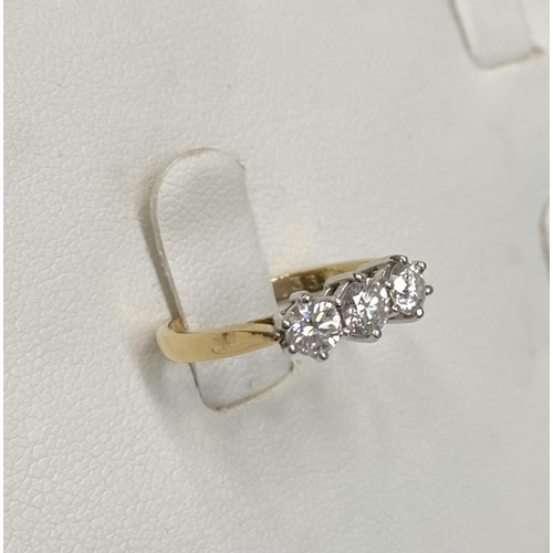 167 - AN 18CT YELLOW GOLD THREE STONE DIAMOND RING, set with three round brilliant cut diamonds, total .90... 