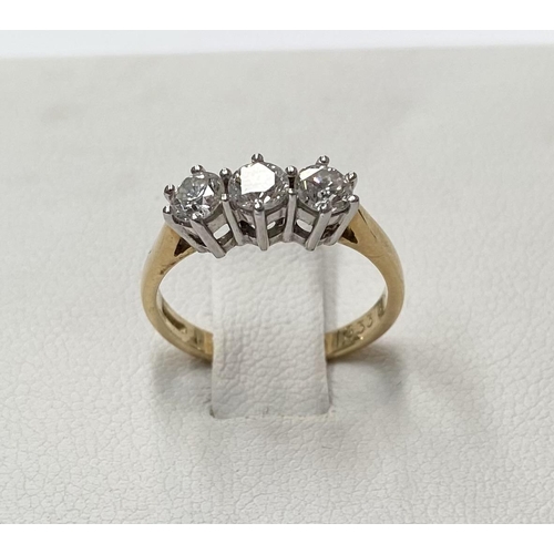 167 - AN 18CT YELLOW GOLD THREE STONE DIAMOND RING, set with three round brilliant cut diamonds, total .90... 