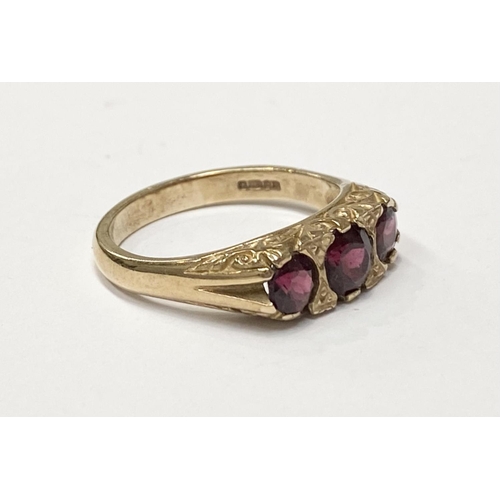 182 - A 9CT YELLOW GOLD THREE STONE GARNET RING, the garnets are set in a super detailed mount , ring size... 