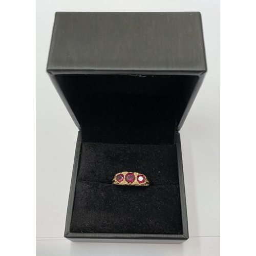 182 - A 9CT YELLOW GOLD THREE STONE GARNET RING, the garnets are set in a super detailed mount , ring size... 