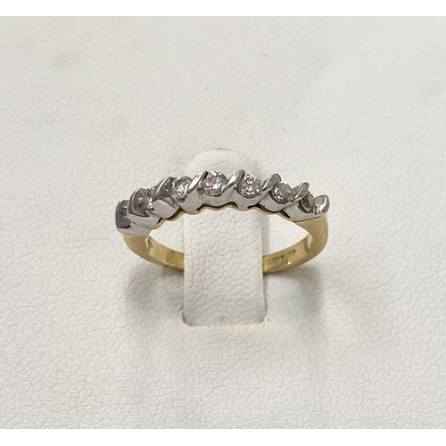 184 - AN 18CT YELLOW GOLD SEVEN STONE DIAMOND RING, the seven diamonds are set in a white gold swirl setti... 