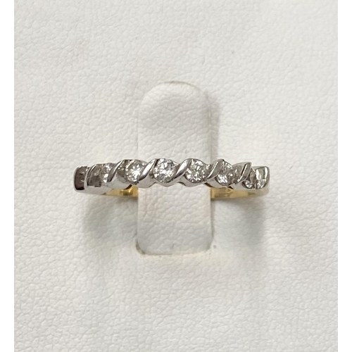 184 - AN 18CT YELLOW GOLD SEVEN STONE DIAMOND RING, the seven diamonds are set in a white gold swirl setti... 