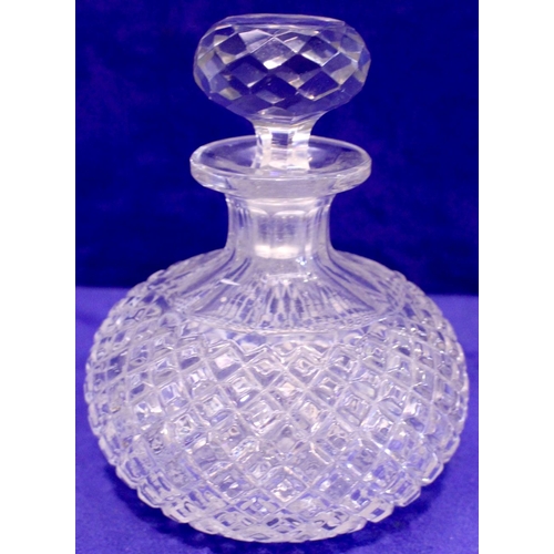 19 - A SMALL CROSSHATCH MOULDED GLASS DECANTER, with broad fluted neck, with stopper, 15cm high approx.