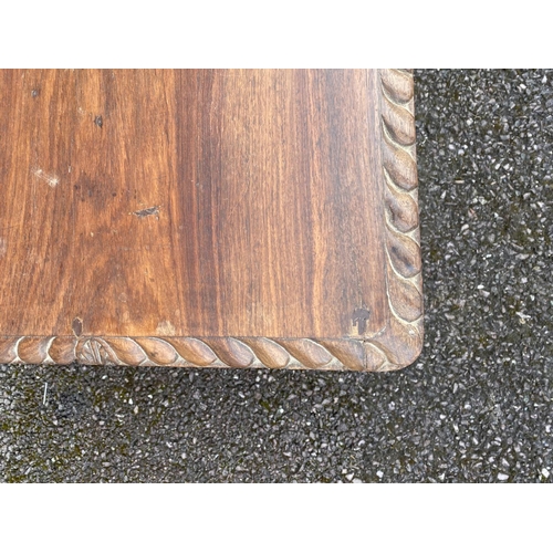 193 - A LATE 19TH CENTURY MAHOGANY SQUARE SIDE/COFFEE TABLE, having a gadroon edge, standing on turned leg... 