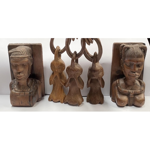 198 - AN ASSORTED COLLECTION OF CARVED WOODEN AFRICAN PIECES, to include (i) a pair of carved wooden booke... 