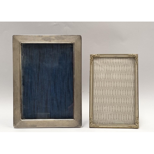 201 - TWO VINTAGE PHOTO FRAMES, one white metal (possibly silver) with engine turned design, the other wit... 