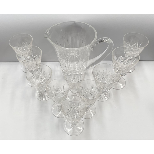 207 - A CUT GLASS LOT TO INCLUDE A WATERFORD CUT GLASS JUG, with star cut base, marked Waterford, along wi... 