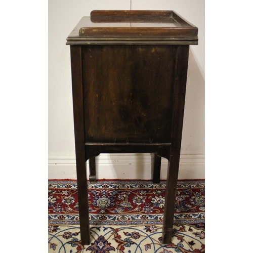 213 - A MAHOGANY BEDSIDE TABLE / LOCKER / LAMP TABLE,	having a raised three quater gallery top, and a sing... 