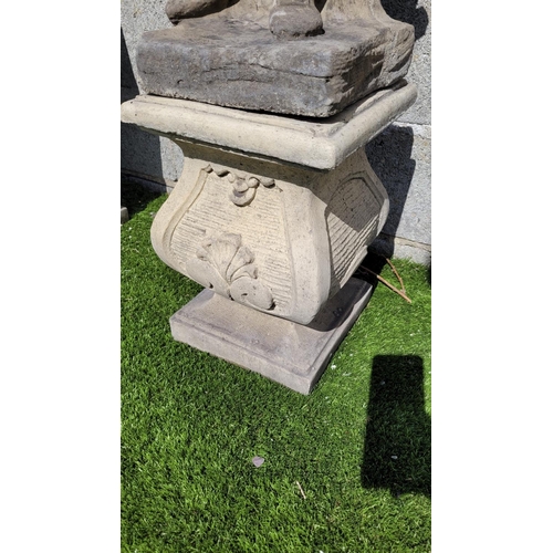 217 - A GARDEN ORNAMENT IN THE FORM OF A FIGURE, 	the stone composite figure stands upon a shaped base, in... 