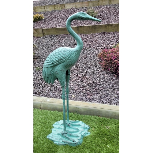 222 - A PAIR OF GARDEN ORNAMENTS IN THE FORM OF TWO HERON BIRDS,	one standing upright the second with its ... 