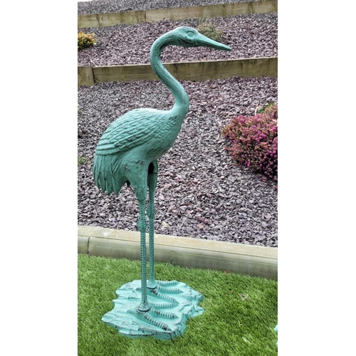 222 - A PAIR OF GARDEN ORNAMENTS IN THE FORM OF TWO HERON BIRDS,	one standing upright the second with its ... 