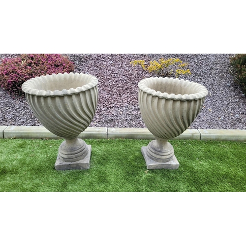 224 - A PAIR OF GARDEN URNS, 	with fantastic barley twist design to the tapered body which sits upon a squ... 