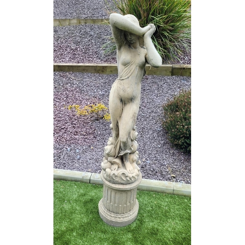 226 - A GARDEN ORNAMENT IN THE FORM OF A FEMALE FIGURE, 	the woman stands upon a column shaped base, her a... 