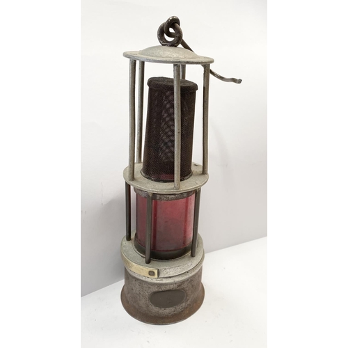 232 - AN ANTIQUE MINERS SAFETY LAMP, this form of lamp was approved for use in mines due to its improved v... 