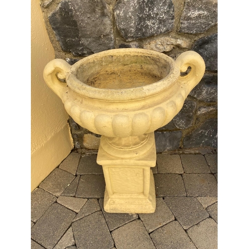 247 - A PAIR OF GARDEN URNS ON STANDS, urns with two handles, fluted base, supported by rectangular plinth... 