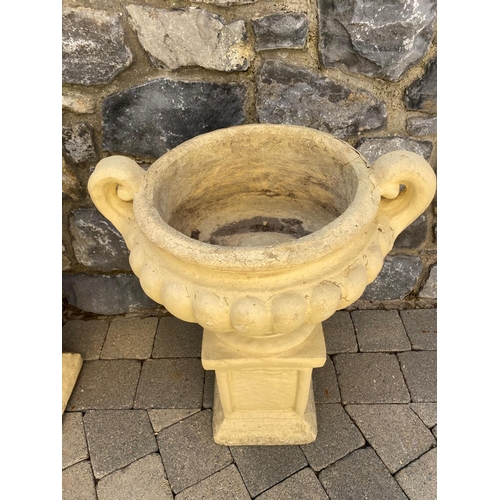 247 - A PAIR OF GARDEN URNS ON STANDS, urns with two handles, fluted base, supported by rectangular plinth... 