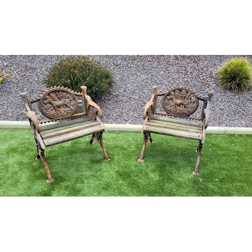 26 - A PAIR OF COALBROOKDALE STYLE CAST IRON GARDEN ARMCHAIRS, 	rust coloured, each with the hunting dog ... 