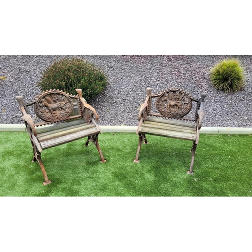 26 - A PAIR OF COALBROOKDALE STYLE CAST IRON GARDEN ARMCHAIRS, 	rust coloured, each with the hunting dog ... 