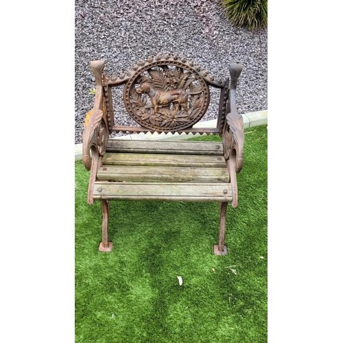 26 - A PAIR OF COALBROOKDALE STYLE CAST IRON GARDEN ARMCHAIRS, 	rust coloured, each with the hunting dog ... 