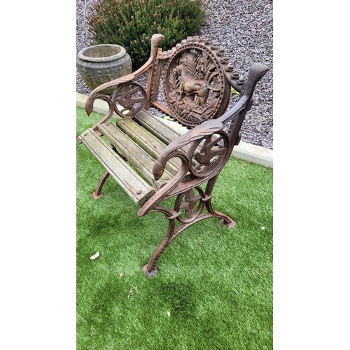 26 - A PAIR OF COALBROOKDALE STYLE CAST IRON GARDEN ARMCHAIRS, 	rust coloured, each with the hunting dog ... 