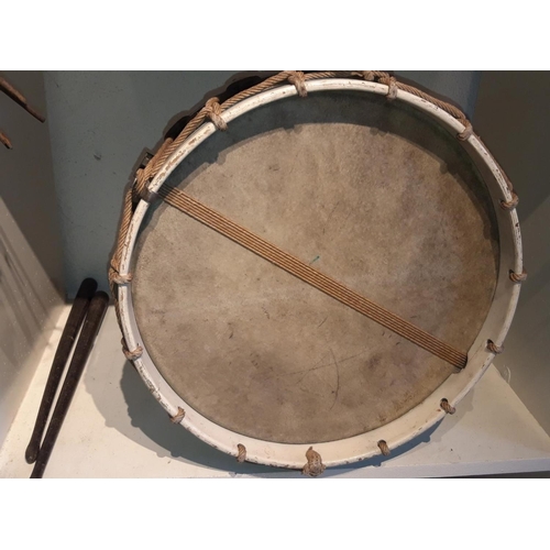 263 - AN ANTIQUE DRUM & DRUMSTICKS, with centre tin drum and wooden frame bound with rope. Comes with a pa... 