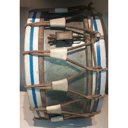 263 - AN ANTIQUE DRUM & DRUMSTICKS, with centre tin drum and wooden frame bound with rope. Comes with a pa... 