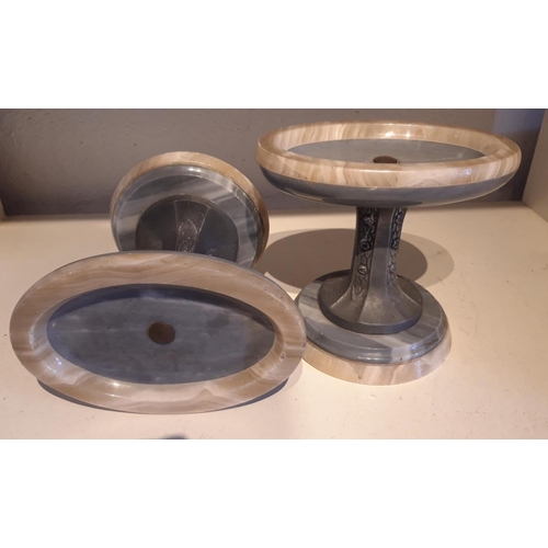 265 - A PAIR OF ART DECO CARVED MARBLE & PEWTER ORNAMENTS / STANDS, with circular tops over a pinched pewt... 