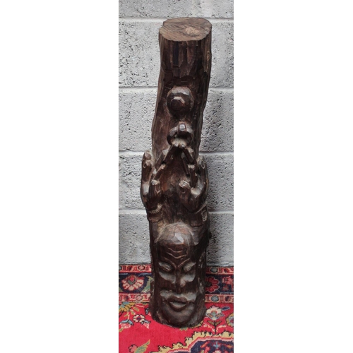 286 - A FIGURATIVE WOODEN SCULPTURAL CARVING, showing a figure with its hands raised above the head held i... 