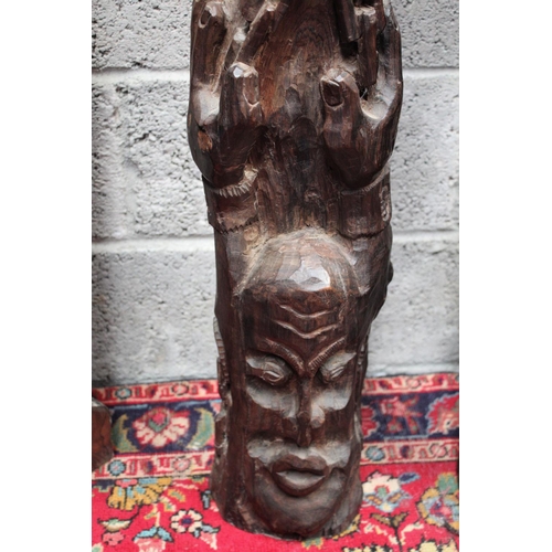 286 - A FIGURATIVE WOODEN SCULPTURAL CARVING, showing a figure with its hands raised above the head held i... 