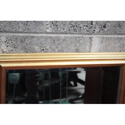 287 - A RECTANGULAR GILT WALL MIRROR, 	a simple and sizeable mirror with a multi-level bevel on the gilt f... 