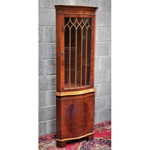 289 - AN EDWARDIAN STYLE CORNER CABINET, 	featuring two compartments divided by prominent bevelling; a lar... 