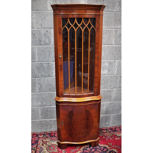 289 - AN EDWARDIAN STYLE CORNER CABINET, 	featuring two compartments divided by prominent bevelling; a lar... 