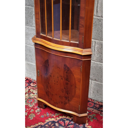 289 - AN EDWARDIAN STYLE CORNER CABINET, 	featuring two compartments divided by prominent bevelling; a lar... 