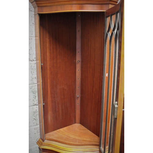 289 - AN EDWARDIAN STYLE CORNER CABINET, 	featuring two compartments divided by prominent bevelling; a lar... 