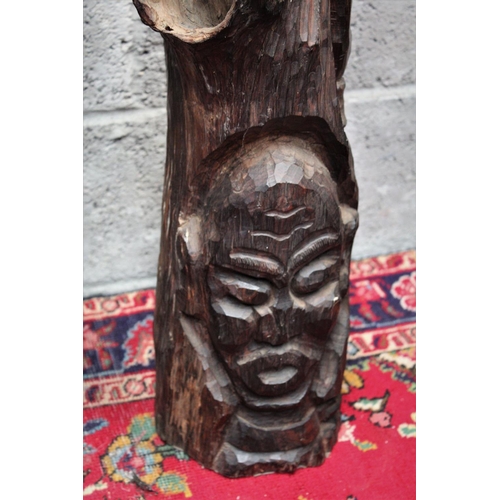 293 - A FIGURATIVE WOODEN SCULTPTURAL CARVING, possibly African in origin. Showing a carved face to the lo... 