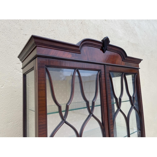 3 - A GOOD QUALITY MAHOGANY CHIPPENDALE STYLE GLZED DISPLAY CABINET, the top with raised centre having a... 