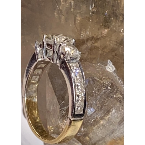 38 - AN 18CT YELLOW & WHITE GOLD DIAMOND THREE STONE RING, with a large central diamond, flanked on eithe... 