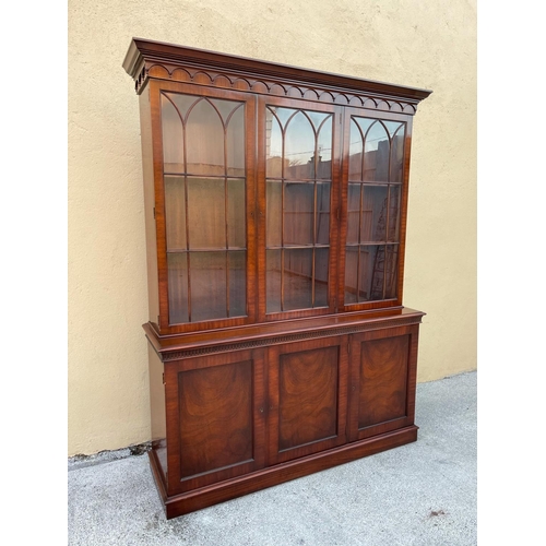 54 - A GOOD MAHOGANY LIBRARY/GLAZED BOOKCASE, with stepped tapered pediment over a band of gadrooned deta... 