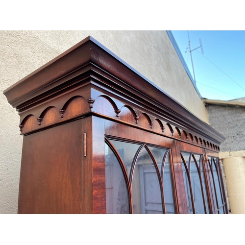 54 - A GOOD MAHOGANY LIBRARY/GLAZED BOOKCASE, with stepped tapered pediment over a band of gadrooned deta... 