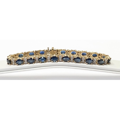 62 - A STUNNING 14CT YELLOW GOLD SAPPHIRE & DIAMOND TENNIS BRACELET, made up of 20 oval faceted sapphire ... 